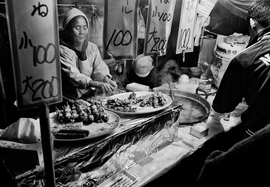 Tokyo – Woman selling shashlik on a festive market in Asakusa